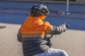 Close up view of young boy in helmet on bicycle.