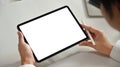 Close up view of young businessman hands holding stylus pen and using digital tablet at working desk. Empty screen for Royalty Free Stock Photo