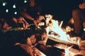 Romantic night. Young people roasting marshmallows over a campfire while enjoying their road travel Royalty Free Stock Photo