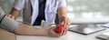 Close up view of young female doctor measuring blood pressure of patient Royalty Free Stock Photo