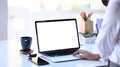 Young female employee hands typing on laptop computer at office desk.