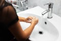 Close-up view of young girl washing her hands under water tap with soap, in white sink. Hygienic concept. Prevention of viruses. Royalty Free Stock Photo
