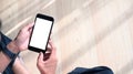 Close up view of young man hands holding mobile phone with blank screen while sitting on floor. Royalty Free Stock Photo