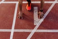 Close up view of young muscular athlete is at the start of the race tracks line at the stadium. Sports concept Royalty Free Stock Photo