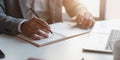 Close-up view of young professional businessman writing his idea concepts on notebook Royalty Free Stock Photo