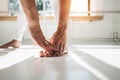 Close up view on young sport woman doing stretching exercises leg in white interior gym Royalty Free Stock Photo