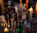 Close up of vintage bottles, flask and candles in alchemy laboratory