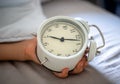 Close up vintage clock in a boy hand, showing time 7am  7oclock in the morning. Royalty Free Stock Photo
