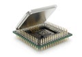 Close up of a vintage computer processor chip with its protective metal lid partially open revealing internal components Royalty Free Stock Photo