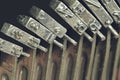 Close up of vintage, dirty typewriter letteters with copy space. Conceptual image of old fashioned office work Royalty Free Stock Photo