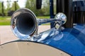 Close-up of the vintage horn on a blue car in the park