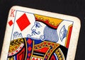 Close up of a vintage king of diamonds playing card on a black background. Royalty Free Stock Photo