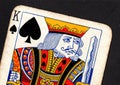 Close up of a vintage king of spades playing card on a black background. Royalty Free Stock Photo