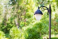 Close up vintage lamp and pole in the garden park. Electrical light in the night. Royalty Free Stock Photo