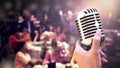 Close up vintage microphone in singer hand singing on stage of wedding event party or business meeting with lighting effect and co