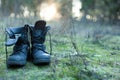 Close up of vintage pair of walking boots on boulder grassland background.