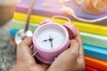 Close up a vintage pink alarm clock in the hands of a woman Royalty Free Stock Photo