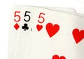 Close up of vintage playing cards showing three fives. Royalty Free Stock Photo