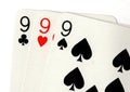 Close up of vintage playing cards showing three nines.