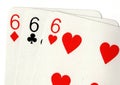 Close up of vintage playing cards showing three sixes. Royalty Free Stock Photo