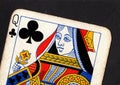 Close up of a vintage queen of clubs playing card on a black background. Royalty Free Stock Photo