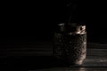 Close up. Vintage silver candlestick with extinguished candle, a trickle of gray smoke. Low key. Black background. Copy space Royalty Free Stock Photo