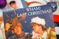 Close up of vintage vinyl record cover singles with famous christmas songs focus on Wham last christmas cover