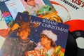 Close up of vintage vinyl record cover singles with famous christmas songs focus on Wham last christmas cover