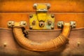 Close up of a vintage weathered brown leather suitcase