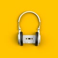 Close up of vintage white audio tape cassette with headset concept illustration on yellow background Royalty Free Stock Photo