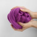 Close-up of violet merino wool ball in hands Royalty Free Stock Photo