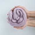 Close-up of violet merino wool ball in hands Royalty Free Stock Photo