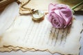 Close up of violet purple rose flower with antique pocket watch and love letters with vintage and vignette tone Royalty Free Stock Photo