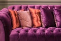 Close up of violet velvet sofa and cushions