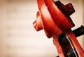 Close Up of Violin Scroll in front of Sheet Music