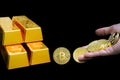 Close-up virtual currency bitcoin and golden bullions isolated on black background Royalty Free Stock Photo