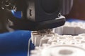 close up on visible layers of helical gear prduced by a FDM-3D-printer with white plastic filament on blue taped build plattform Royalty Free Stock Photo