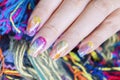 Close up vivid Colorful gel polish painting cute galaxy nail art on beautiful woman fingernail