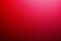 Close-up of vivid red textured wall surface with subtle light gradient creating a vibrant and dynamic background for creative Royalty Free Stock Photo
