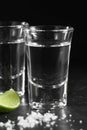 Close up vodka in shot glass on black background