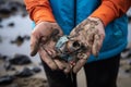 A close up of a volunteer\'s hand holding a piece of trash