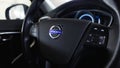 Close up Volvo logo on the steering wheel. Volvo V40 dashboard interior. Royalty Free Stock Photo