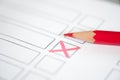 Close up voting bulletin with red pencil. Concept of election. Royalty Free Stock Photo