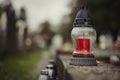 Close up of Votive candles lantern on the grave in Slovak Catholic cemetery during day. Autumn scene. All Hallows eve. Memorial Royalty Free Stock Photo