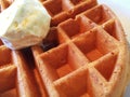 A Close Up Of A Waffle With Butter On Top