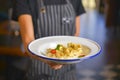 Close up of waiter serving asian dumplings in bowl, Chinese dumplings for dinner. Restaurant service Royalty Free Stock Photo