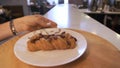 Close-up of waitress carrying tray. Stock footage. Waitress carries tray of croissants in coffee shop. Waitress carries Royalty Free Stock Photo