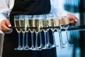 Close Up Of Waitress Serving Glasses Of Champagne At Event