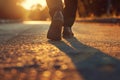 Close-up of walking feet on sunlit road, symbolizing a journey or goal achievement