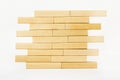 Close-up wall built with toy wooden blocks jenga. wooden brick tower on a white background Royalty Free Stock Photo